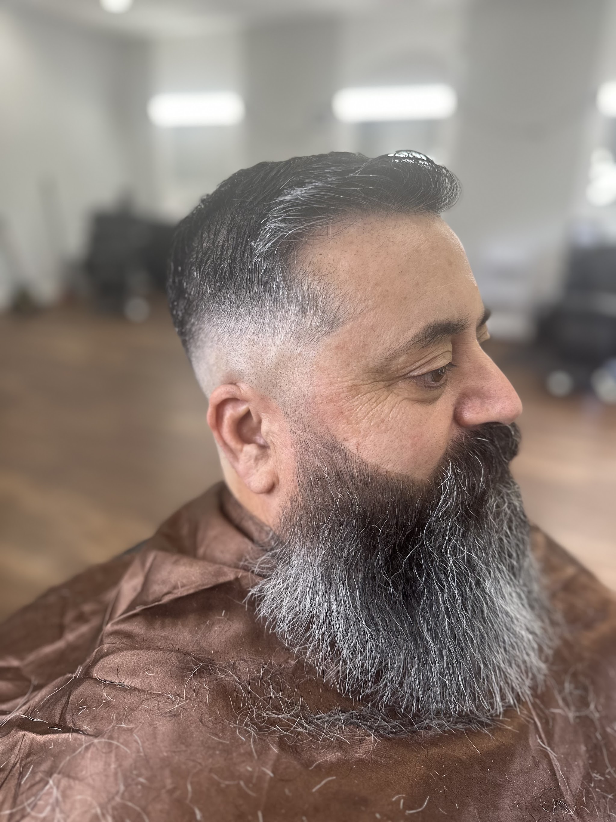Skin fade with a full grey beard, shaped and trimmed